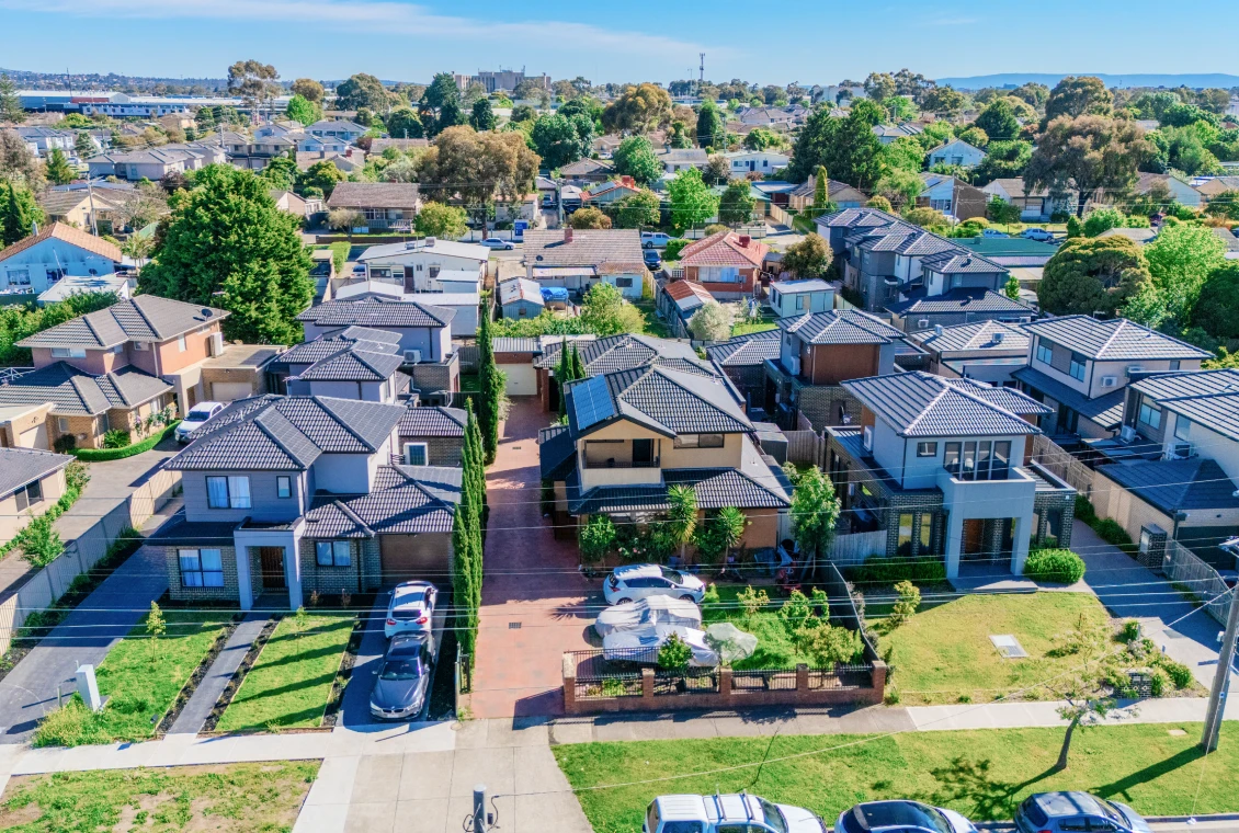 Suburban neighborhood with houses and greenery.